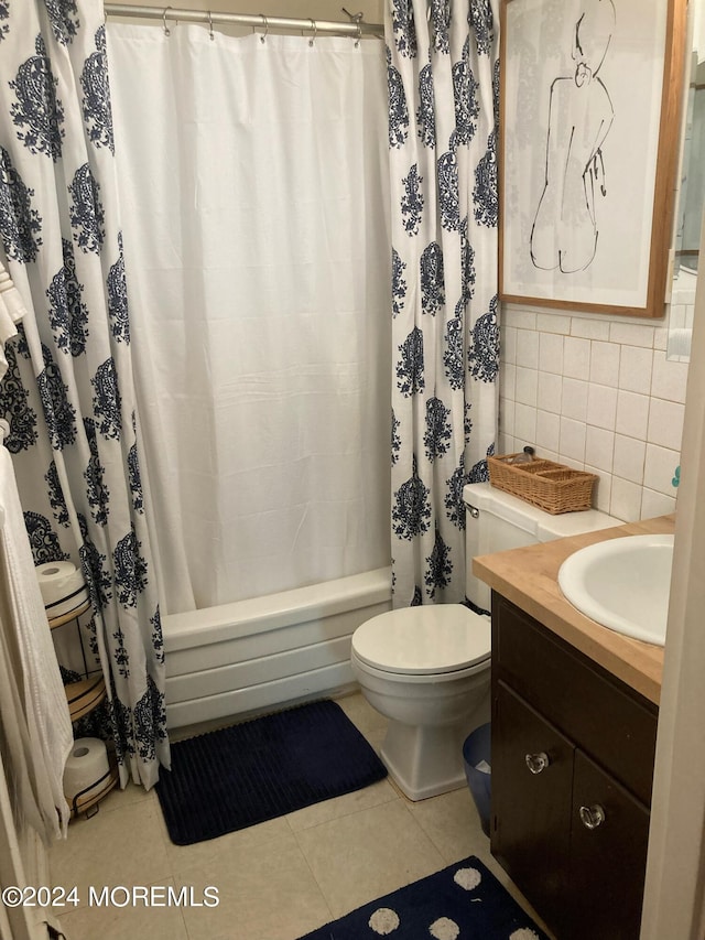 full bathroom with vanity, shower / tub combo, tile patterned floors, tile walls, and toilet