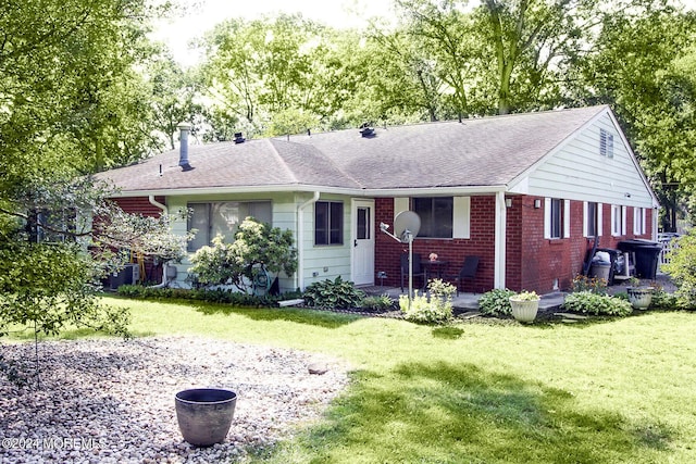 ranch-style home with roof with shingles, brick siding, and a front lawn