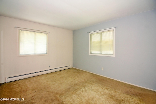 empty room with carpet floors and baseboard heating