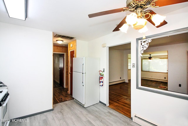 kitchen featuring light wood finished floors, white appliances, baseboard heating, and visible vents