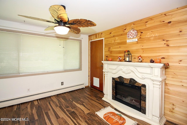 unfurnished living room featuring ceiling fan, a baseboard radiator, dark wood-style flooring, a fireplace, and visible vents