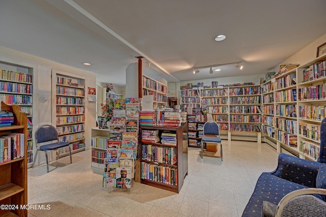 living area featuring built in shelves and bookshelves