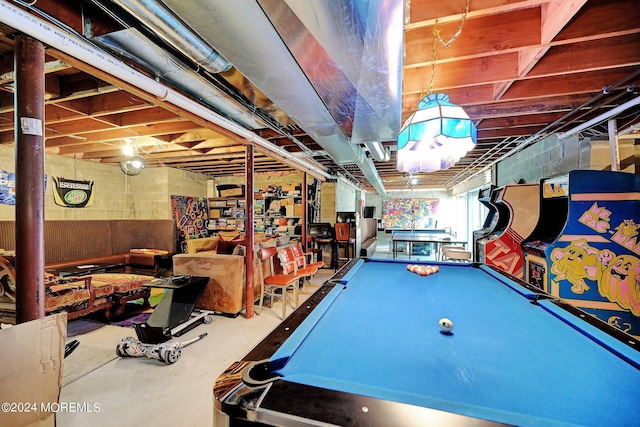 playroom with concrete flooring and concrete block wall