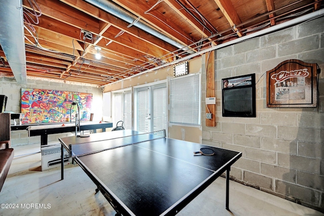 playroom with concrete block wall and concrete flooring