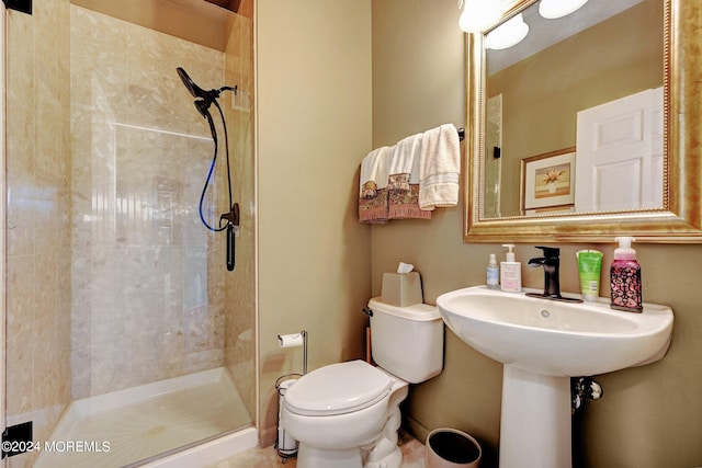 full bathroom featuring a stall shower and toilet