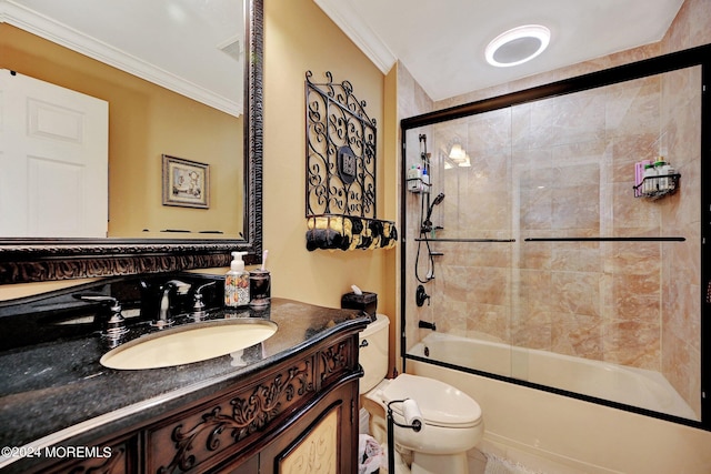 full bathroom featuring combined bath / shower with glass door, ornamental molding, vanity, and toilet