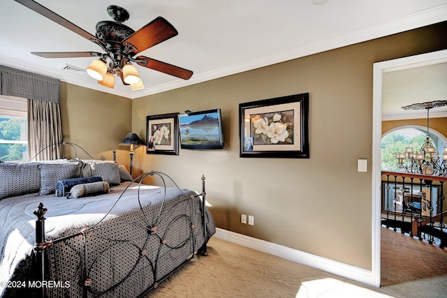 bedroom featuring baseboards, visible vents, ornamental molding, and light colored carpet