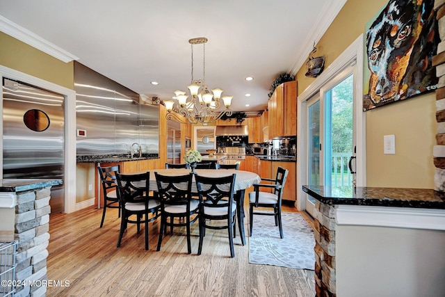 dining space featuring light wood finished floors, recessed lighting, crown molding, and an inviting chandelier