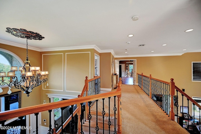 hallway featuring recessed lighting, crown molding, an upstairs landing, and an inviting chandelier