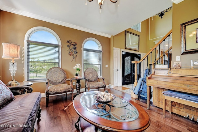 living room featuring ornamental molding, stairway, wood finished floors, and baseboards