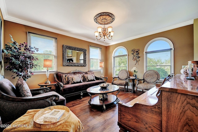 living area featuring wood finished floors, crown molding, and an inviting chandelier