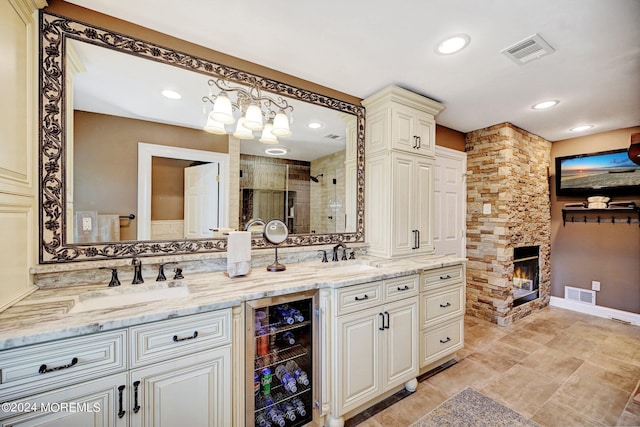 bathroom featuring a stall shower, wine cooler, visible vents, and a sink