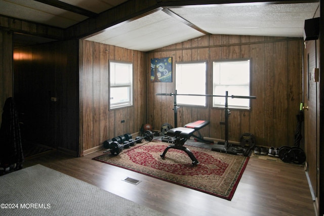 living area with wooden walls, hardwood / wood-style floors, and lofted ceiling