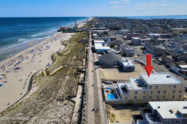 aerial view with a water view and a view of the beach