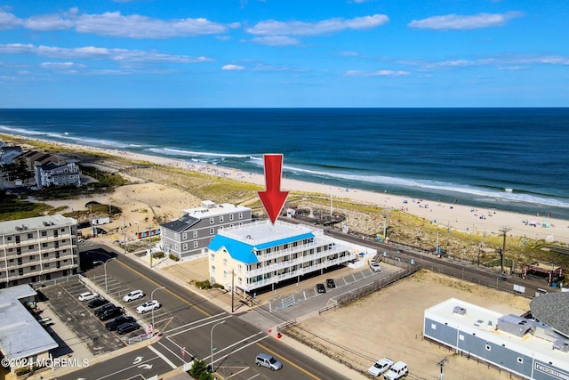 birds eye view of property with a view of the beach and a water view