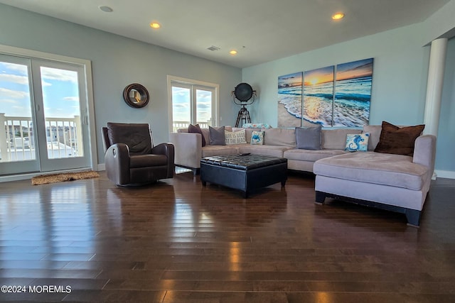 living area with dark wood-style floors, visible vents, recessed lighting, and baseboards