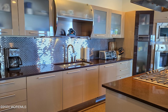 kitchen featuring backsplash, appliances with stainless steel finishes, modern cabinets, and a sink