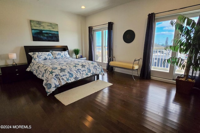 bedroom with recessed lighting, baseboards, multiple windows, and wood finished floors