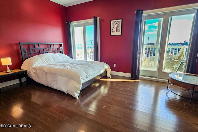 bedroom featuring wood finished floors and baseboards