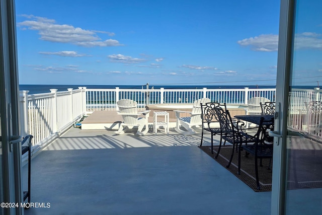 view of patio with outdoor dining space and a water view