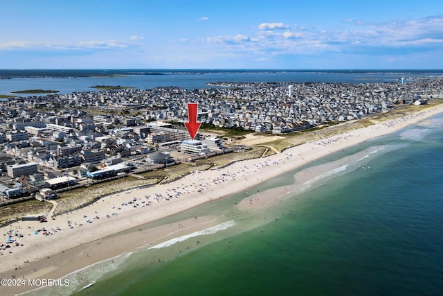 birds eye view of property featuring a water view and a view of the beach