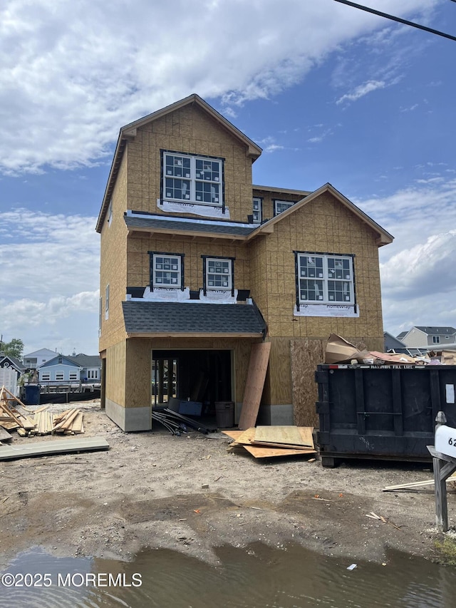 property under construction featuring roof with shingles
