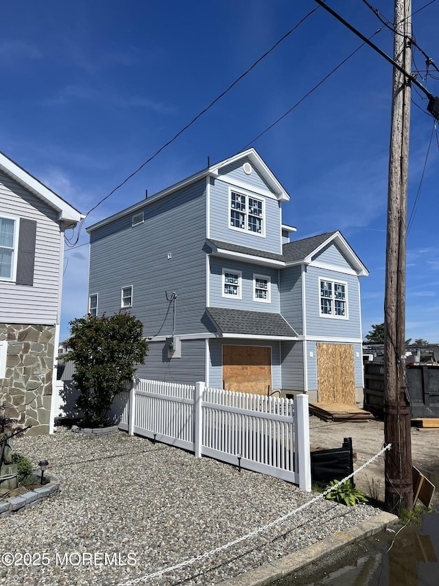62 W Anchor Dr, Little Egg Harbor, NJ 08087 - coastal inspired home featuring roof with shingles and a fenced front yard