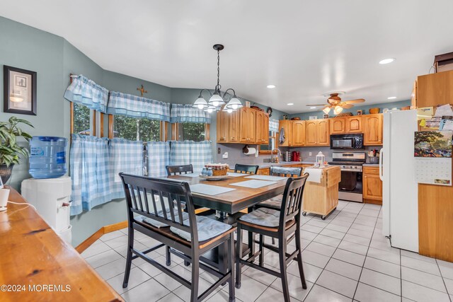 dining area featuring ceiling fan with notable chandelier, recessed lighting, and light tile patterned floors