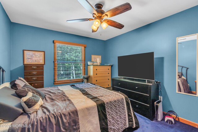 carpeted bedroom with a ceiling fan and baseboards