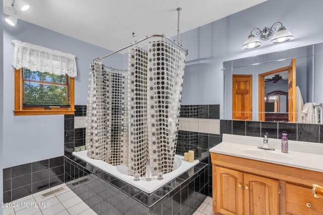 bathroom featuring vanity, tile patterned flooring, and tile walls