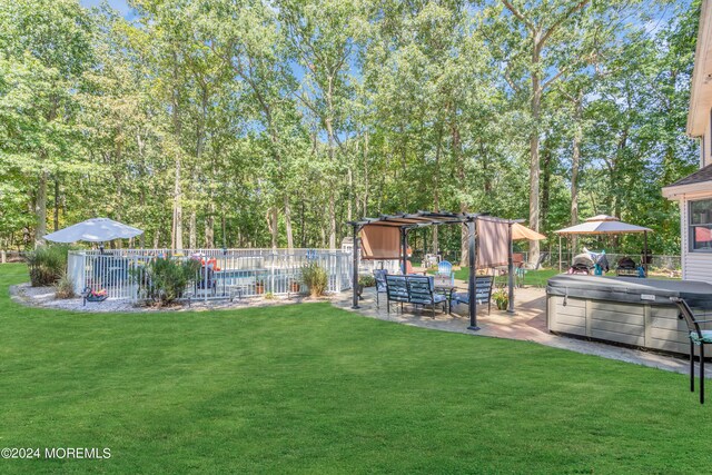 view of yard with a hot tub, fence, a patio area, a pool, and a pergola