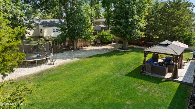 view of yard featuring a trampoline and a gazebo