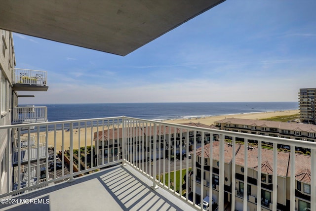 balcony with a water view, central air condition unit, and a view of the beach