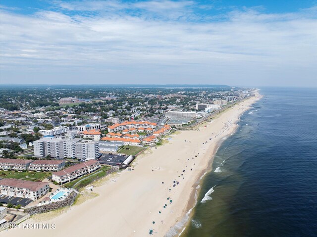 bird's eye view featuring a water view and a beach view