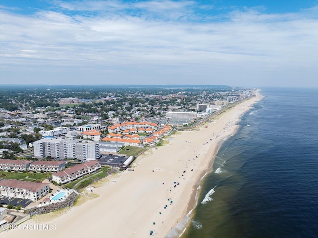 aerial view featuring a water view, a beach view, and a city view