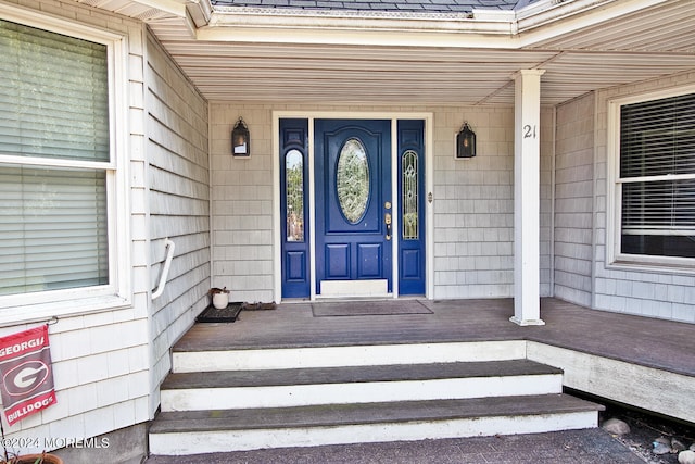 view of exterior entry with a porch