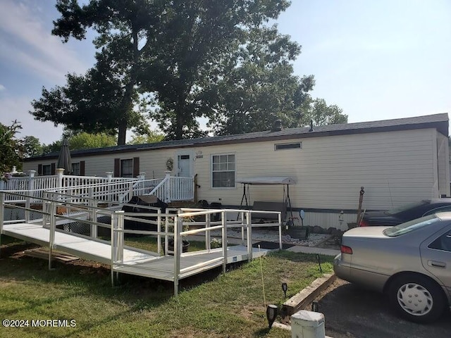 back of house featuring a deck