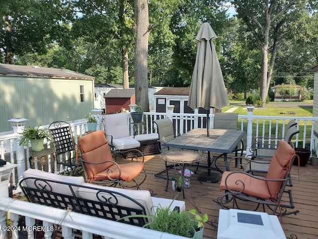 wooden terrace featuring a lawn and a storage unit