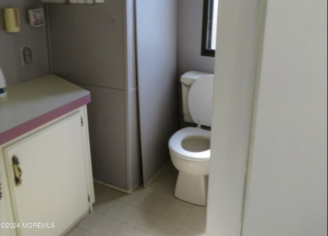 bathroom with tile patterned flooring and toilet