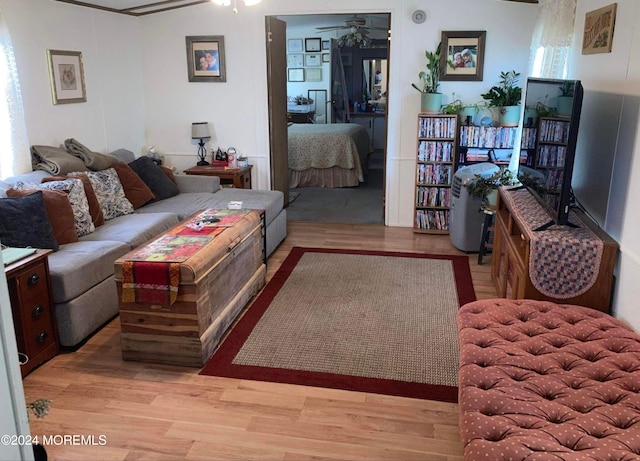 living room featuring lofted ceiling, light hardwood / wood-style flooring, and ceiling fan