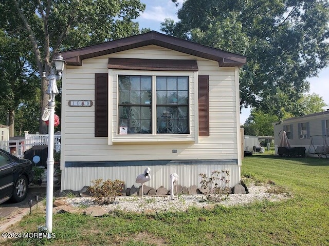 view of home's exterior with a lawn