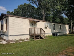 rear view of house with a yard