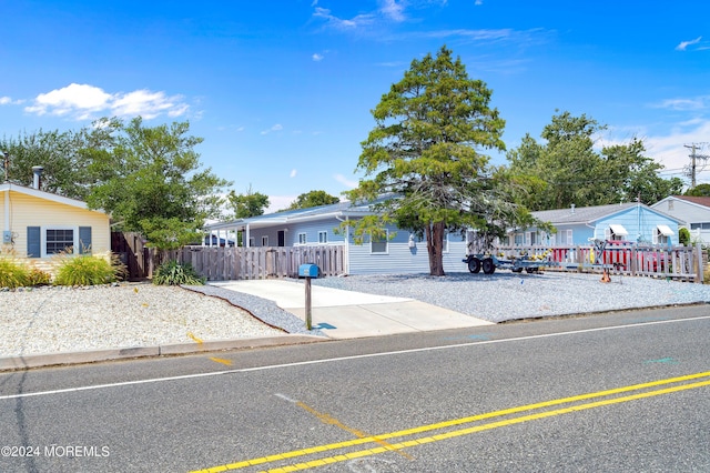 ranch-style home featuring fence