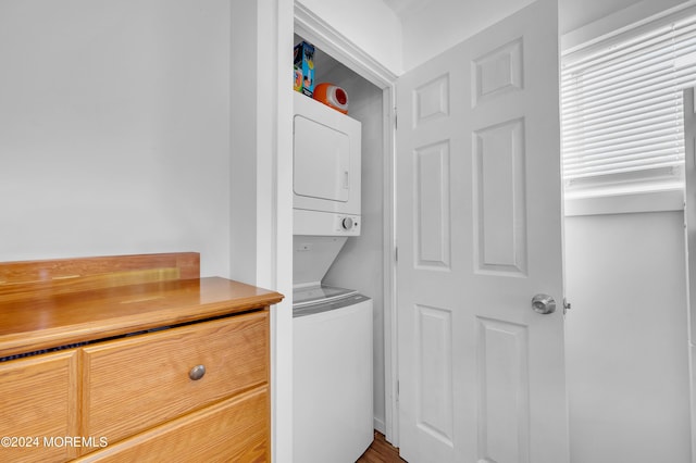 laundry area with laundry area and stacked washer / dryer