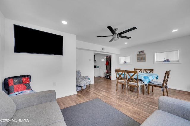 living room featuring ceiling fan, wood finished floors, visible vents, and recessed lighting