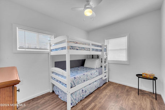 bedroom with a ceiling fan, baseboards, and wood finished floors