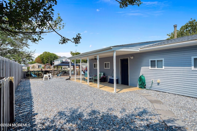 back of house featuring a patio area, a playground, and a fenced backyard