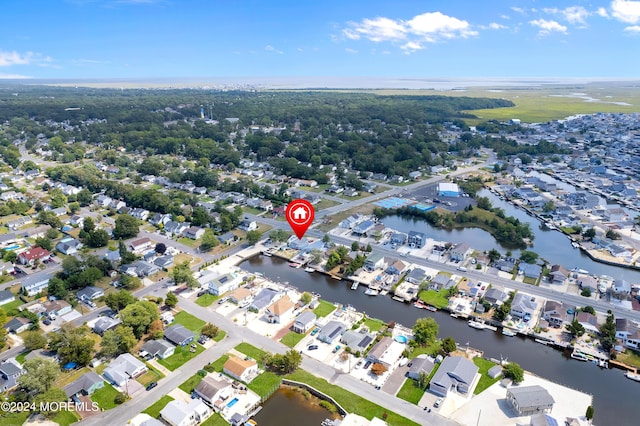 drone / aerial view with a water view and a residential view