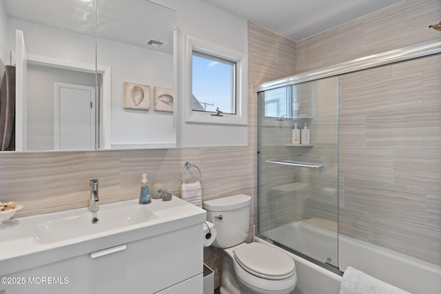 149 Valencia Dr, Brick, NJ 08723 - bathroom with vanity, tile walls, and combined bath / shower with glass door