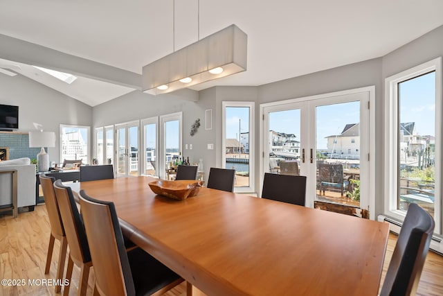 149 Valencia Dr, Brick, NJ 08723 - dining area featuring french doors, light wood-style floors, vaulted ceiling, a skylight, and a ceiling fan